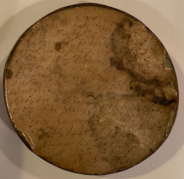 Circle of parchment with faded handwriting