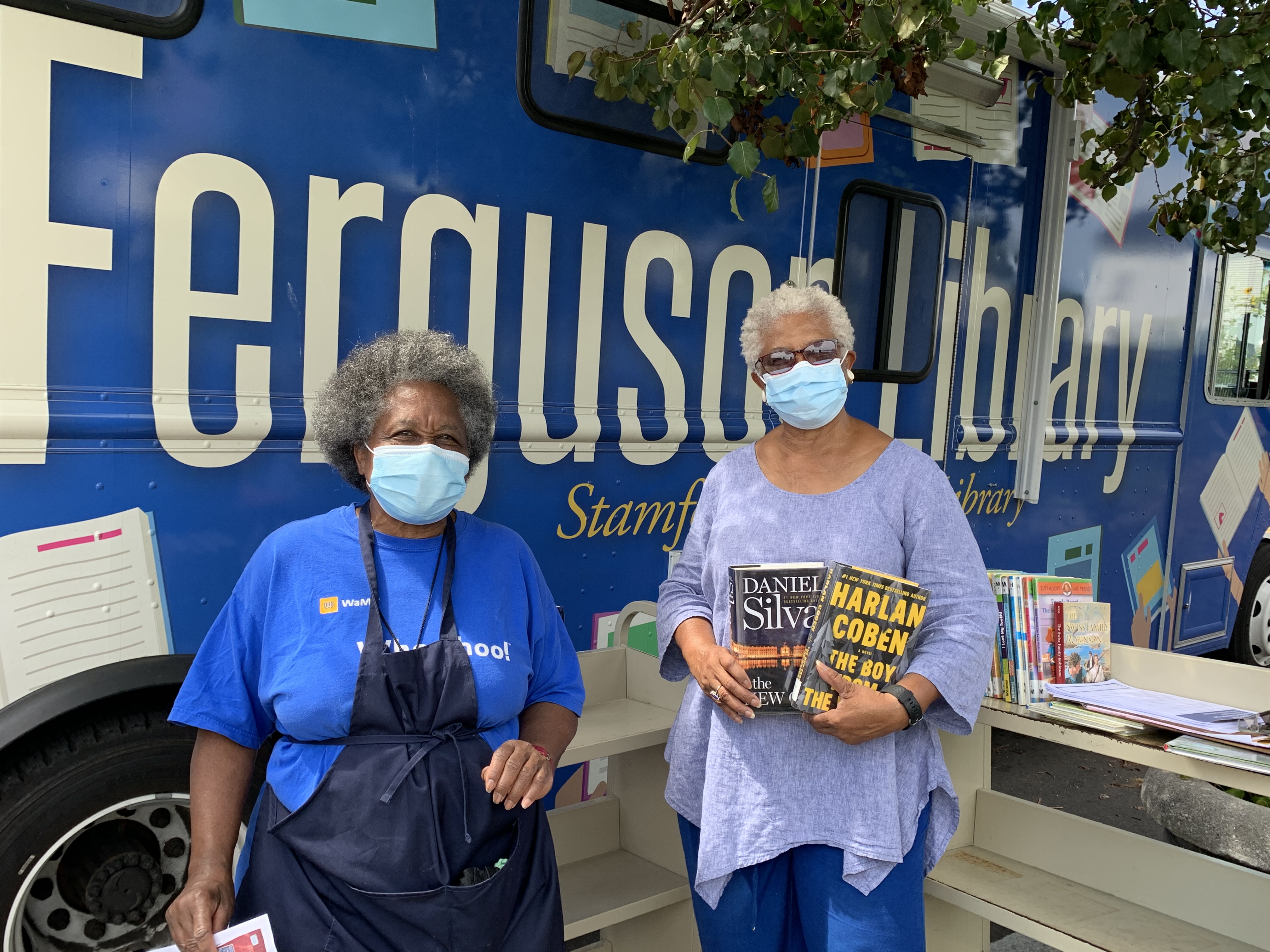 Bookmobile at Fairgate Farms with two patrons selecting books