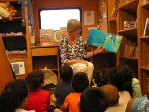 Librarian reads to children on the bookmobile
