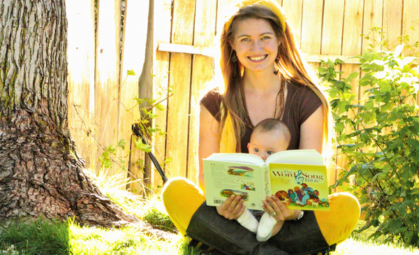 Mom with a baby in her lap and an open storybook